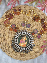 Silver Circular Pendant with Orange Central Picture