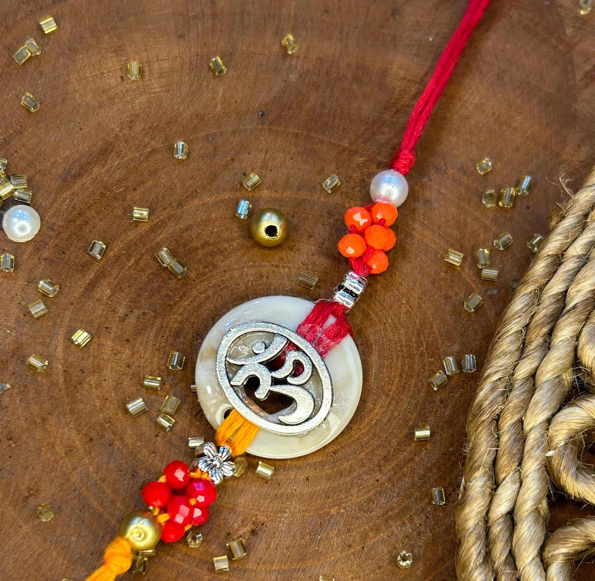 Silver Metal OM Charm Rakhi with Beads